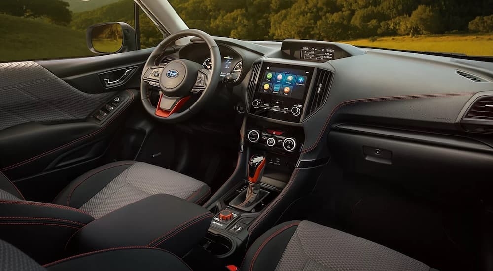 The black interior of a 2024 Subaru Forester Wilderness is shown from the passenger seat.