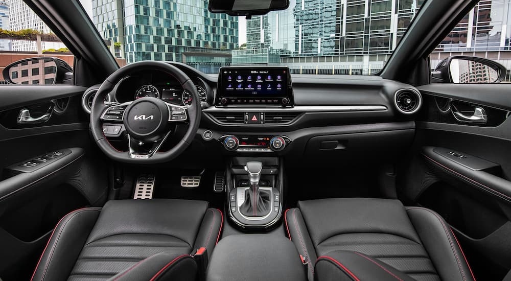 The black interior of a 2024 Kia Forte seen from above the center console.