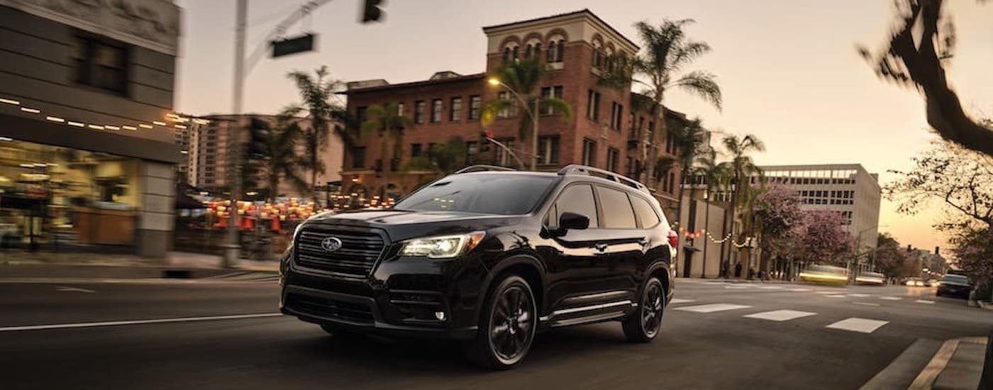 A black 2022 Subaru Forester is shown from the front at an angle after getting a tire rotation.