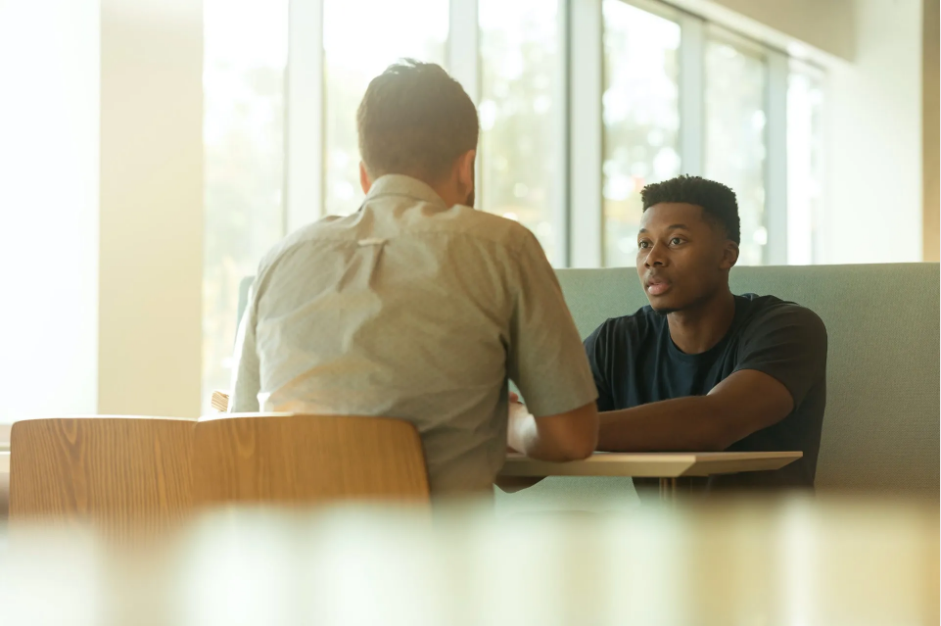 Two people discussing at a dealership. (A Quality Finance Team That Works For You)