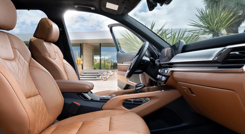 The brown and black interior of a 2024 Kia Telluride, seen from the passenger's seat.