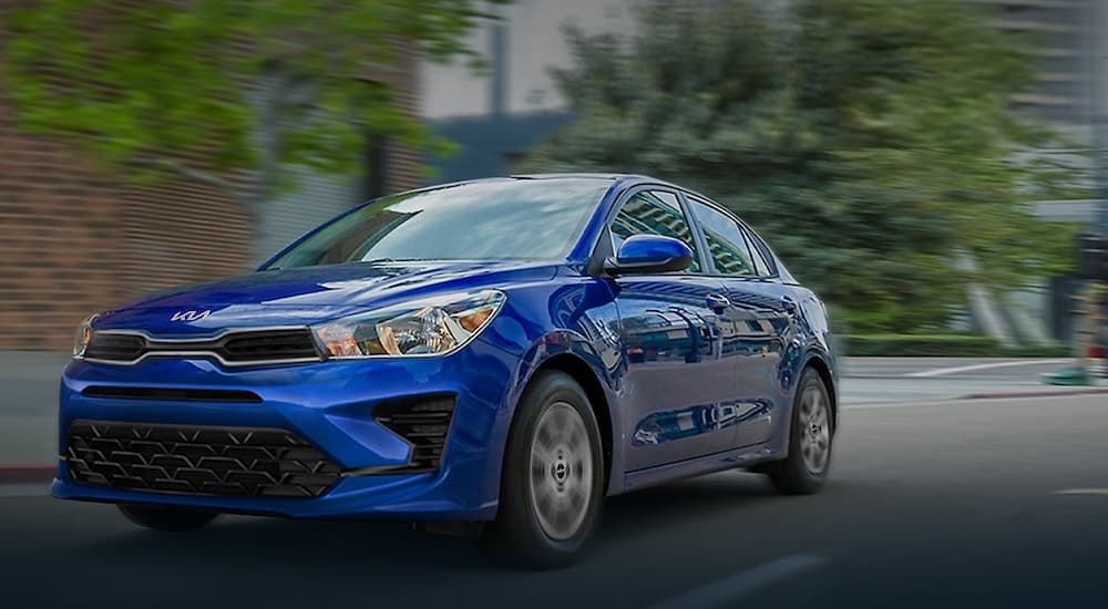 A blue 2023 Kia Rio is shown from the front at an angle after leaving a Kia dealer.