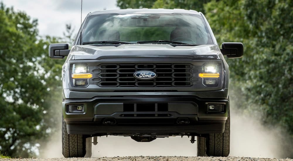A grey 2024 Ford F-150 XL STX is shown from the front after leaving a dealer that has Ford trucks for sale near Red Hook.