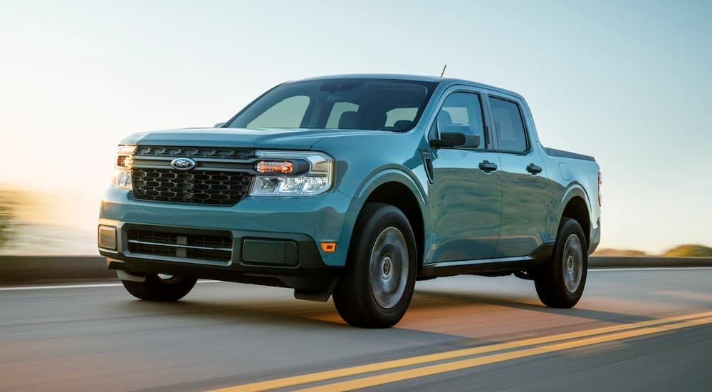 A blue 2024 Ford Maverick is shown from the front at an angle after leaving a dealer that has Ford trucks for sale near Red Hook.