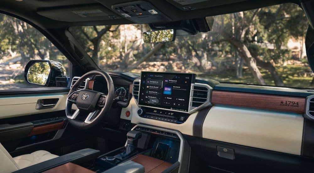 The white and brown interior of a 2024 Toyota Tundra 1794 Edition is shown from the passenger seat.