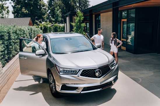 people standing around an acura mdx in houston tx John Eagle Acura