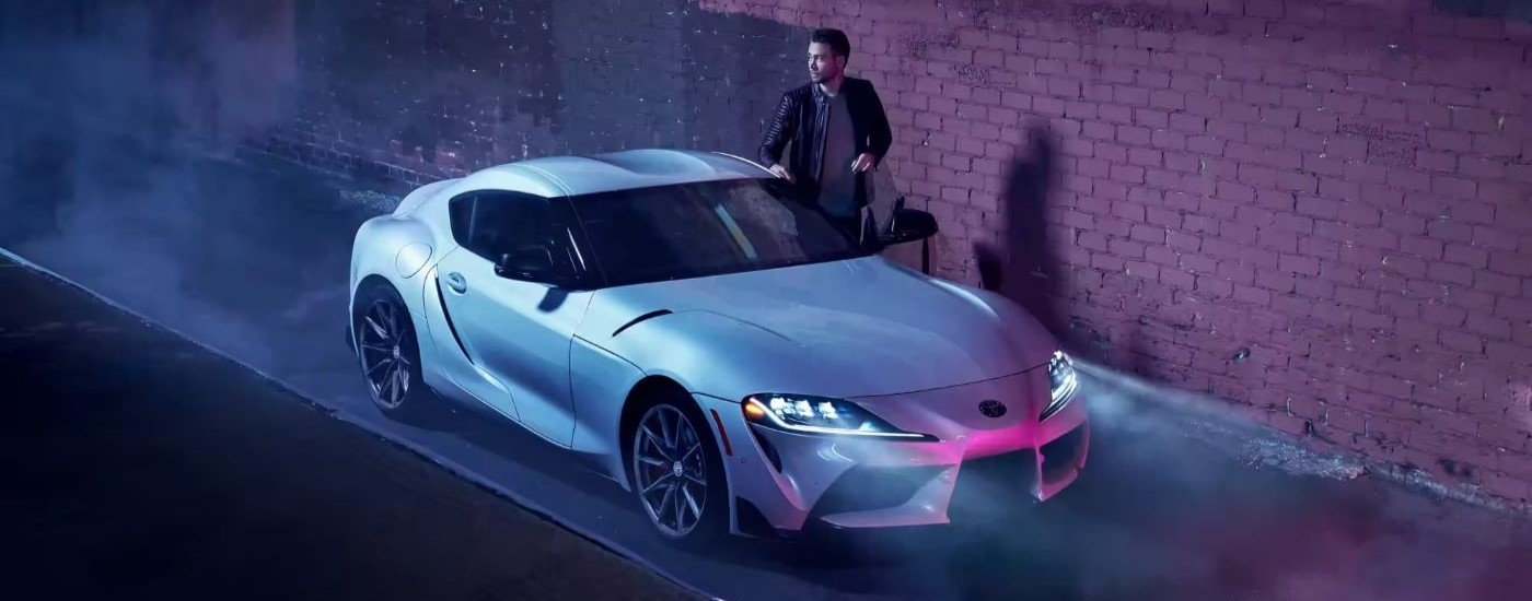 A silver 2023 Toyota GR Supra is shown in an alleyway after leaving a Toyota dealer.