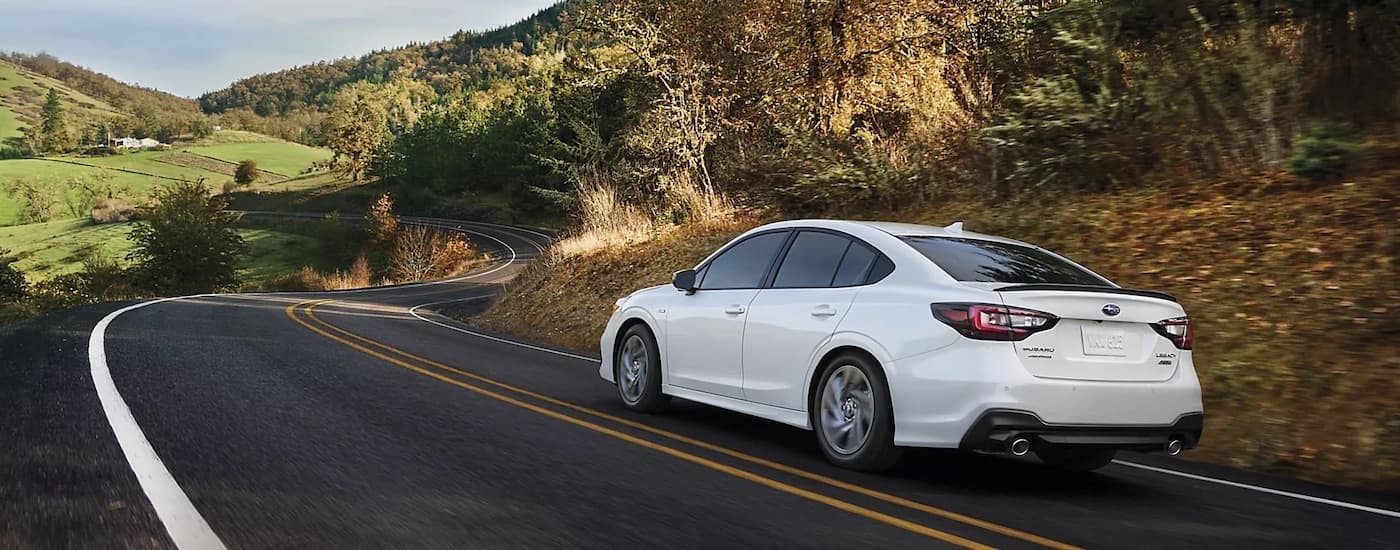 A white 2024 Subaru Legacy is shown from the rear at an angle.