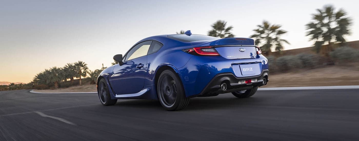A blue 2023 Subaru BRZ is shown from the rear at an angle after leaving a car dealership near Hudson.