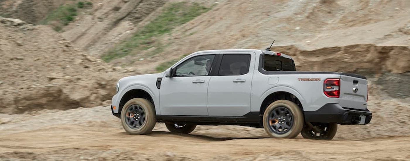 A grey 2024 Ford Maverick Tremor is shown from the side while off-road.
