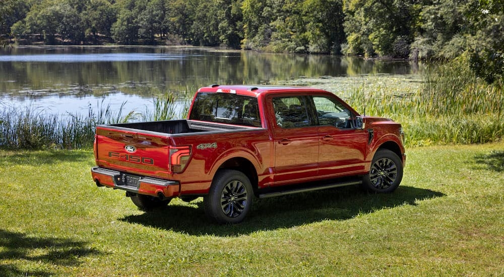 A red 2024 Ford F-150 Lariat is shown fromt he rear at an angle after leaving a dealer that has Ford trucks for sale near Poughkeepsie.