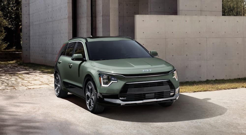 A green 2023 Kia Niro is shown from the front at an angle.