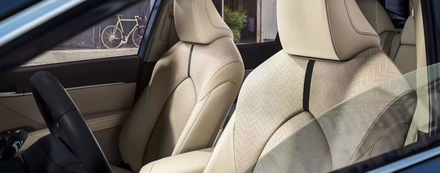 The tan seats are shown in a blue 2024 Toyota Camry XLE.