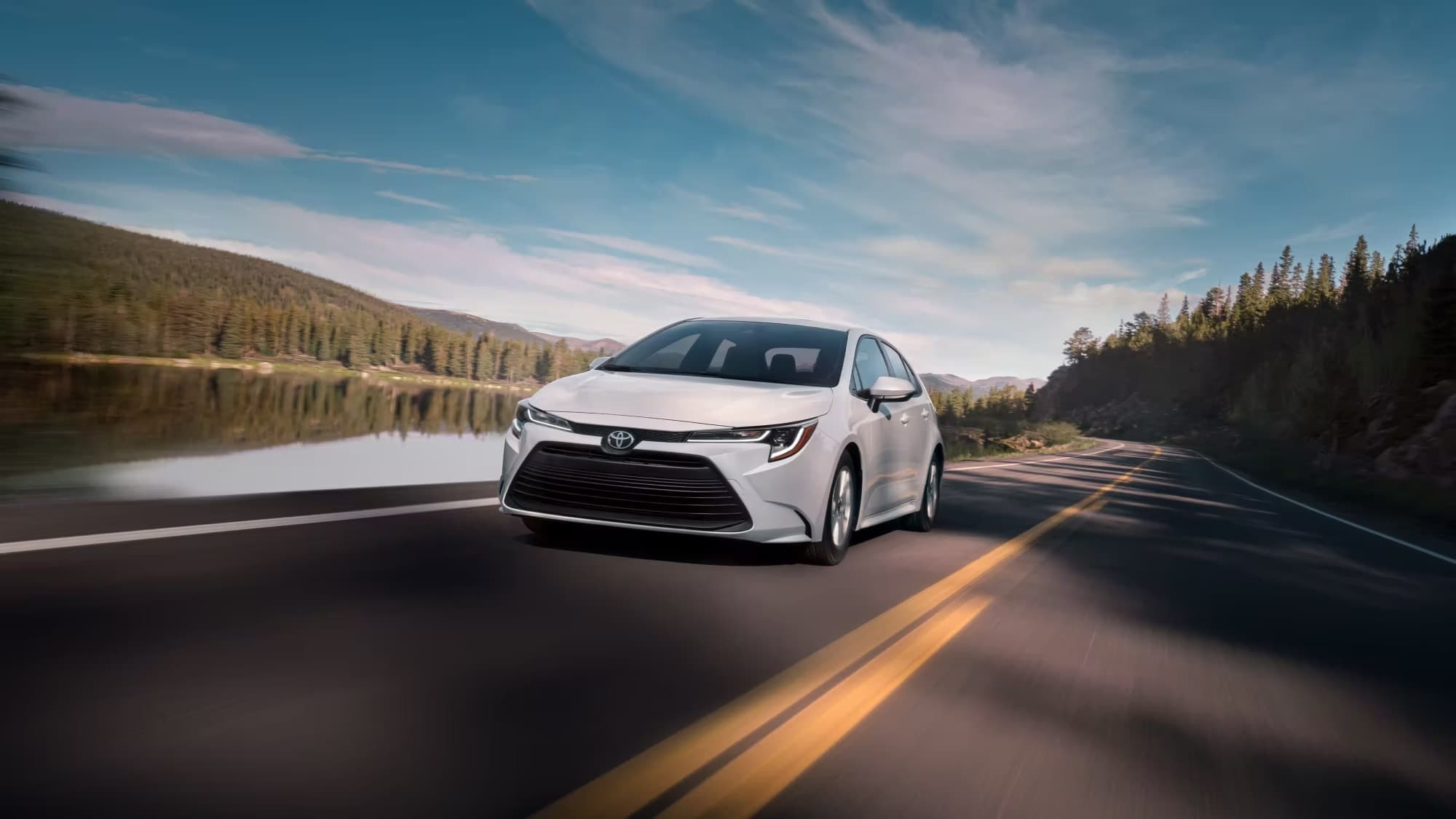 A white 2023 Toyota Corolla is shown from the front at an angle after leaving a used Toyota dealer.