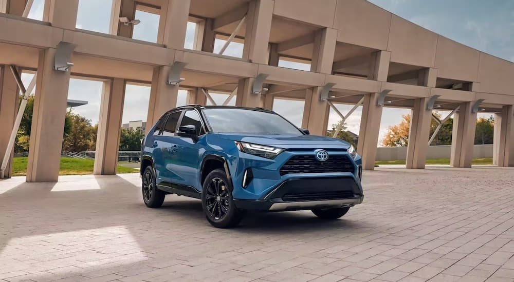 A blue 2022 Toyota RAV4 is shown from the front at an angle after leaving a used Toyota dealer.