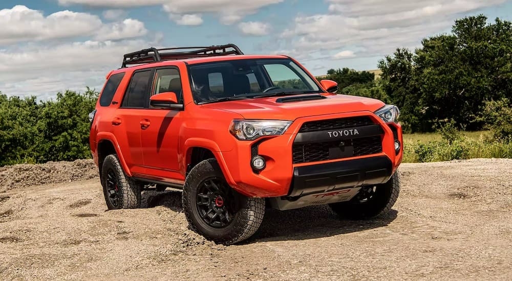 An orange 2023 Toyota 4Runner TRD Pro is shown from the front at an angle while off-road.