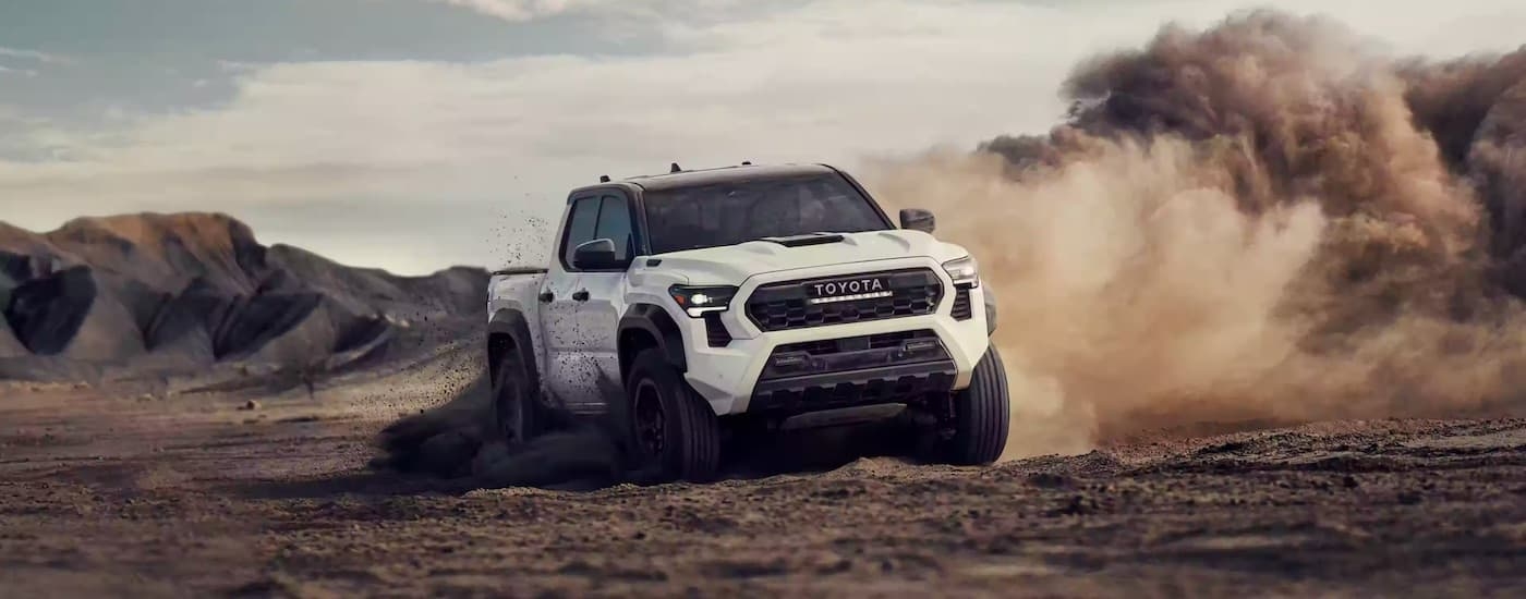 A white 2024 Toyota Tacoma TRD Pro is shown from the front at an angle after leaving a Toyota dealer near Franklin.