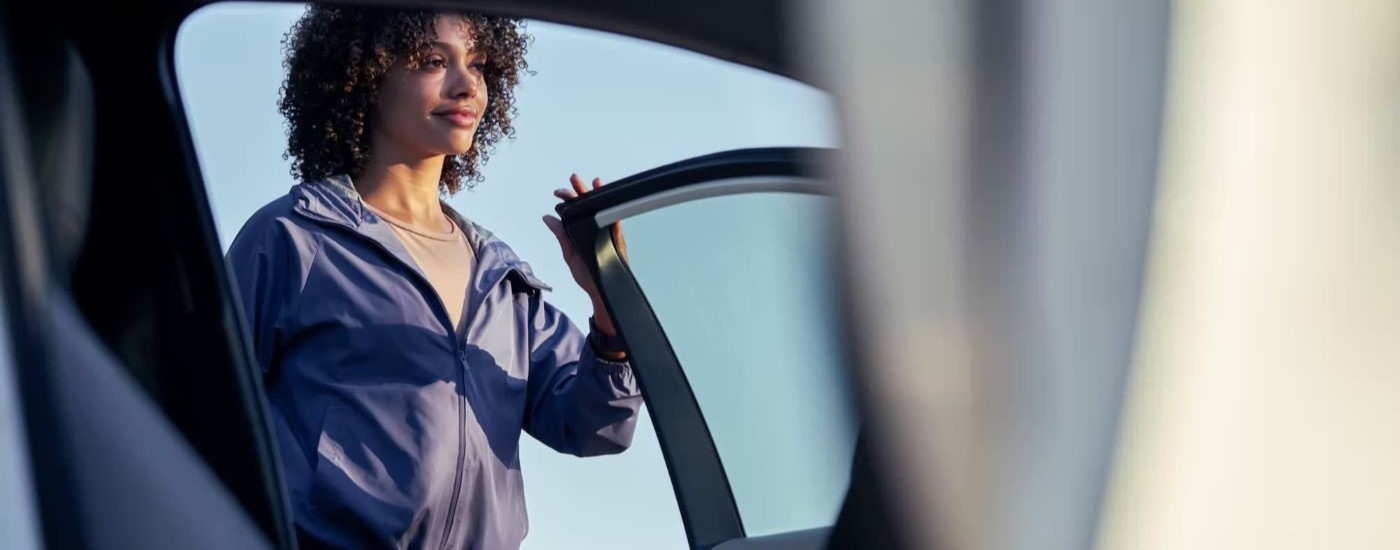 A person is shown opening the door of a white 2024 Toyota Corolla LE.