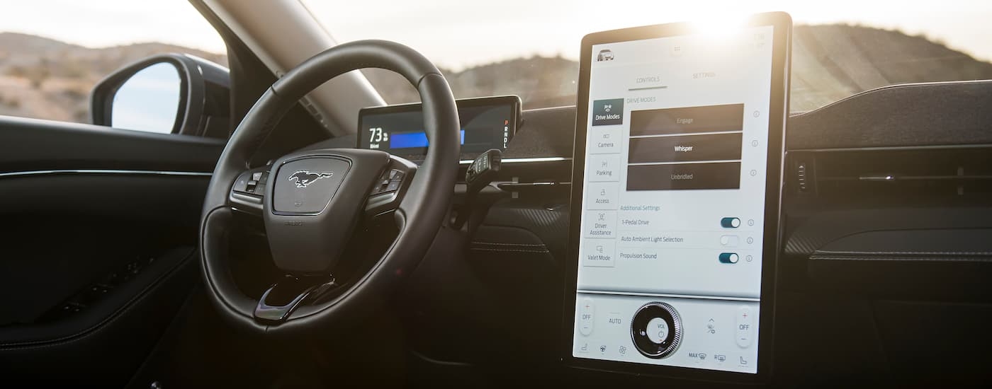 The black interior of a 2024 Ford Mustang Mach-E is shown from the passenger side.