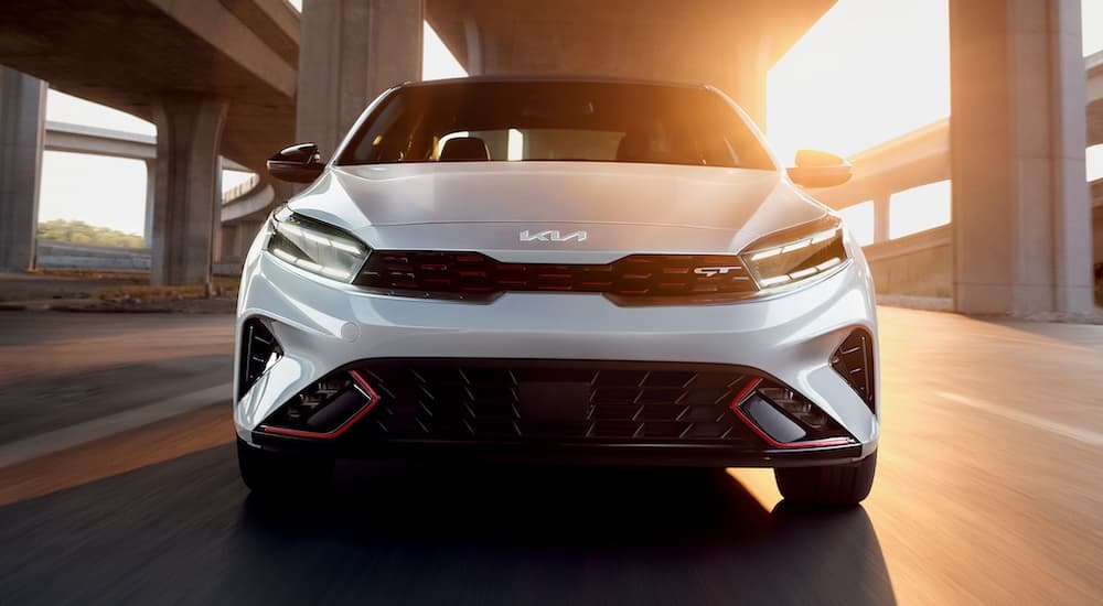 A white 2024 Kia Forte GT is shown from the front after leaving a dealer that has a Kia Forte for sale.