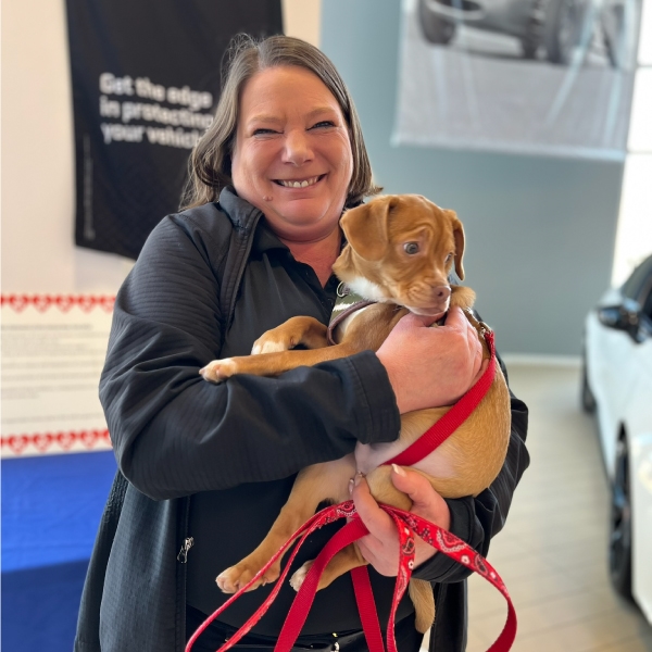  Smiling woman holding dog