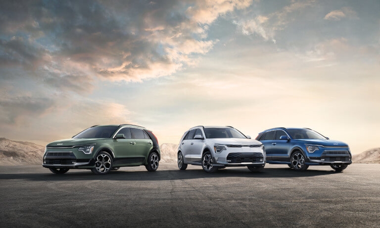 Three 2024 Kia Niro Hybrids parked in mountains