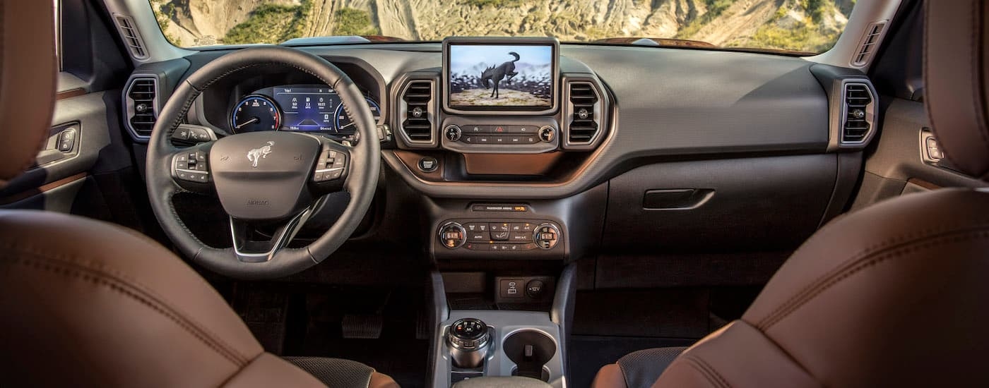 The brown interior of a 2024 Ford Bronco Sport is shown from above the center console looking forward.