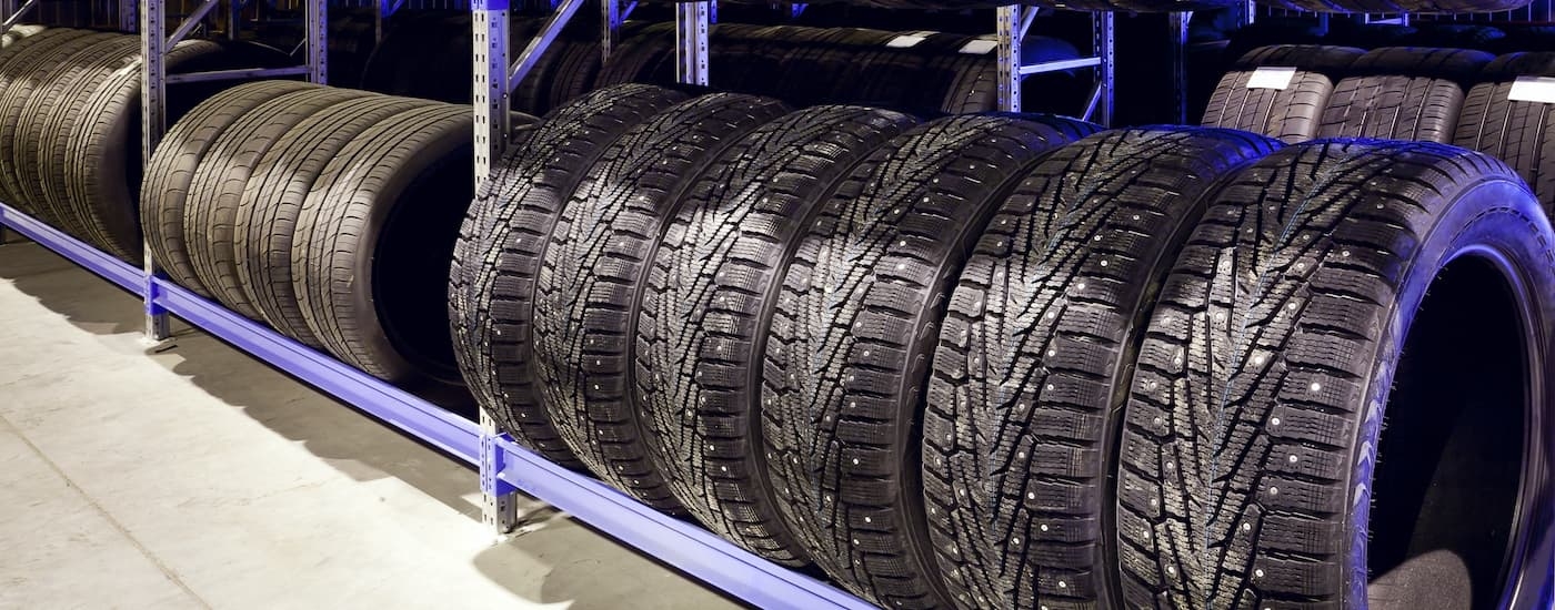 A rack of various types of tires for sale are shown.