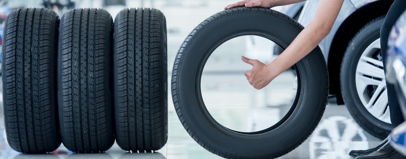 A mechanic is shown inspecting a set of tires.