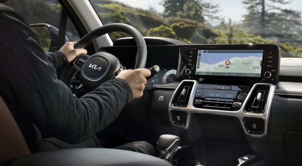 A person is shown steering a 2022 Kia Sorento.