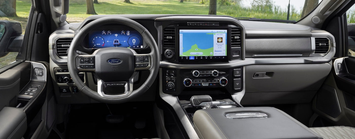 The black interior of a 2024 Ford F-150 Platinum is shown from the driver's seat.
