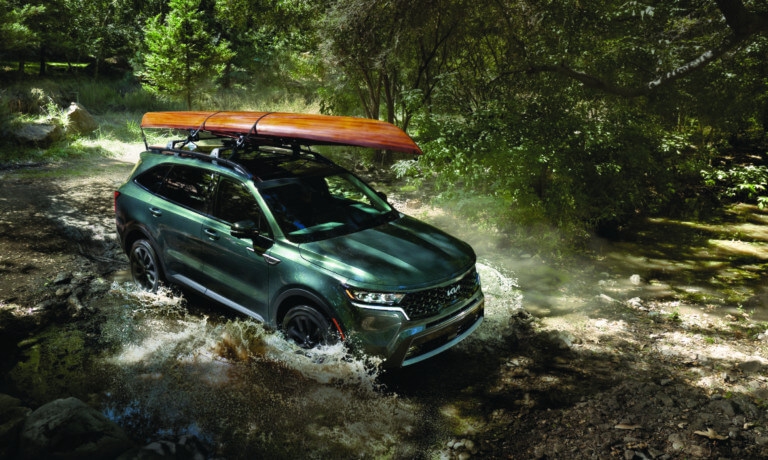 2024 Kia Sorento driving in stream with kayak