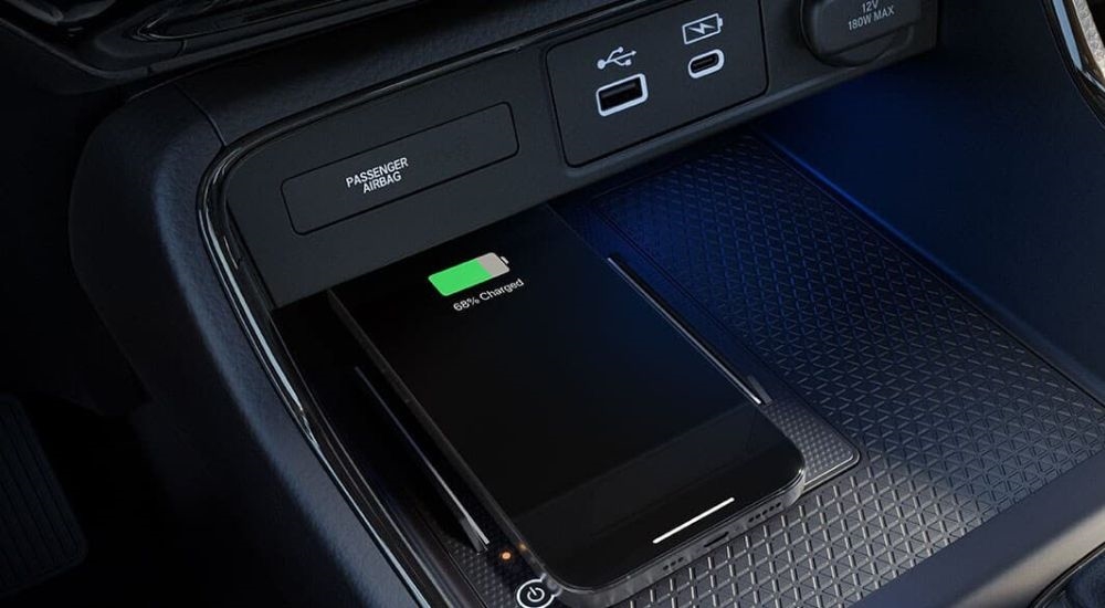 A close up shows a phone charging in a 2024 Honda CR-V.