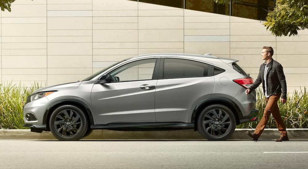 A silver 2022 Honda HR-V is shown from the side parked on a city street after viewing used cars near Union City.