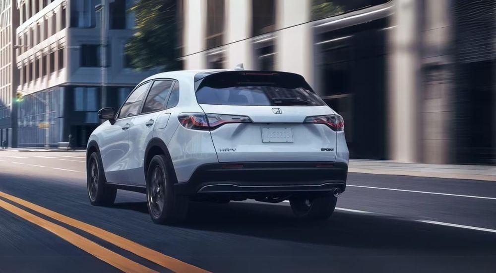 A white 2024 Honda HR-V is shown from the rear at an angle.
