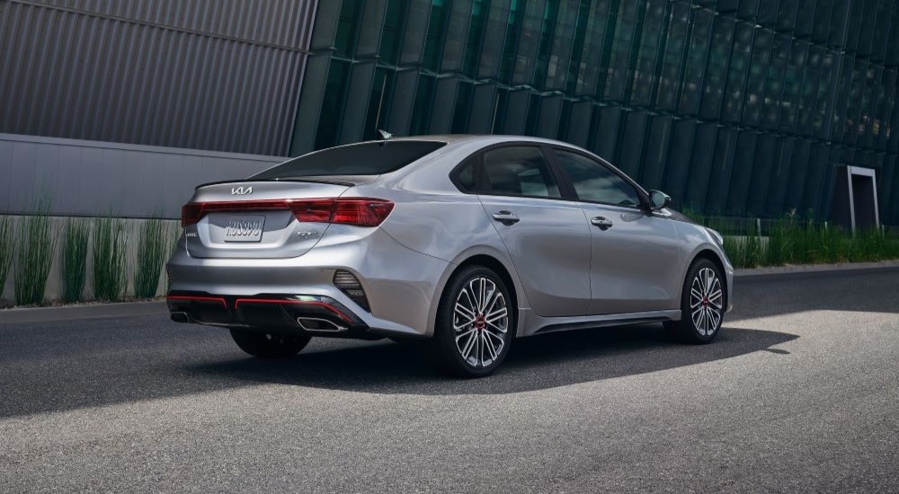 A grey 2022 Kia Forte GT parked at a used car dealership.