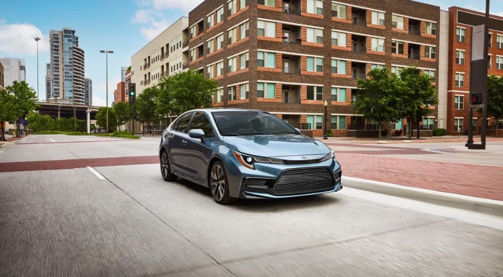 A blue 2022 Toyota Corolla XSE driving on a city street.