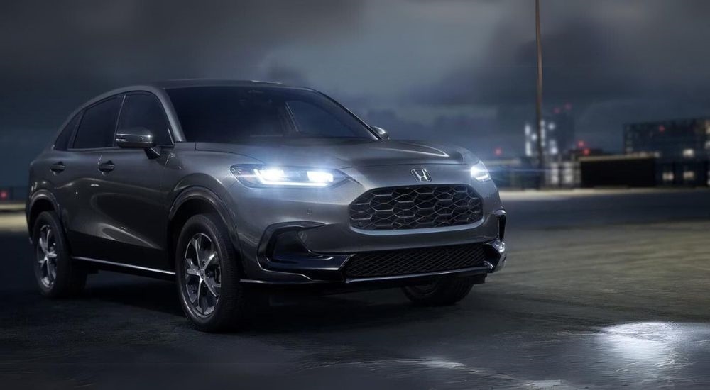 A grey 2023 Honda HR-V parked on a rooftop at night.