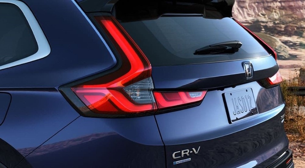 A close up of the rear of a blue 2024 Honda CR-V parked in the desert.
