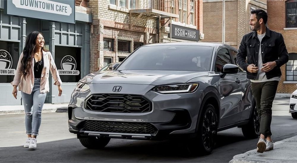 A grey 2024 Honda HR-V Sport is shown in front of a cafe.