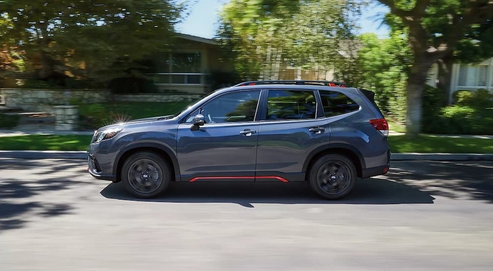 A gray 2024 Subaru Forester Sport is shown driving to visit a Subaru dealer near Hudson.