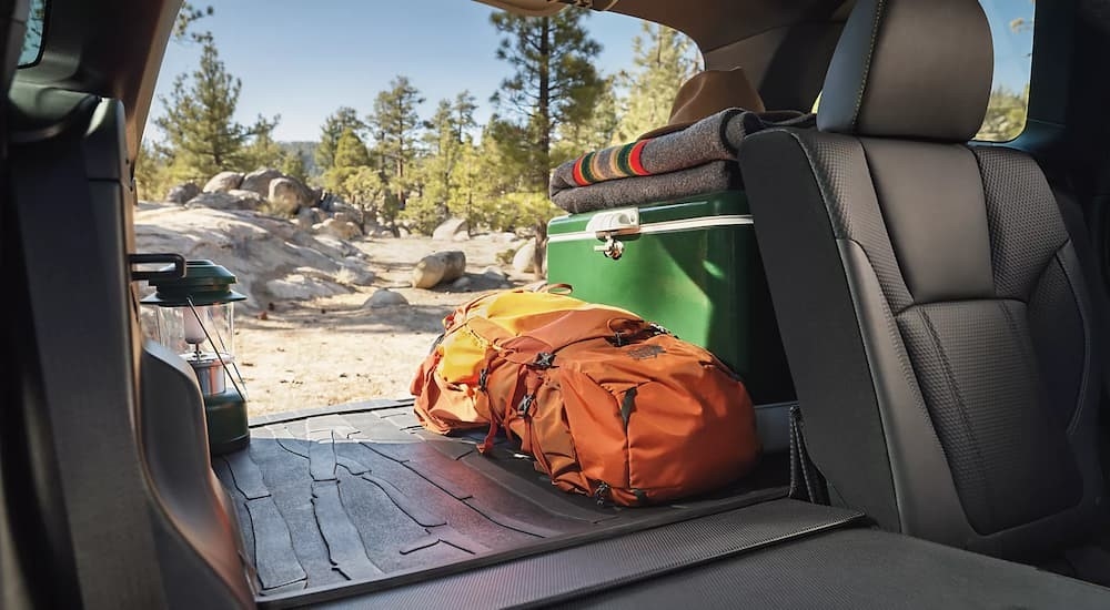 The black interior and rear cargo area is shown in a 2024 Subaru Forester Sport.