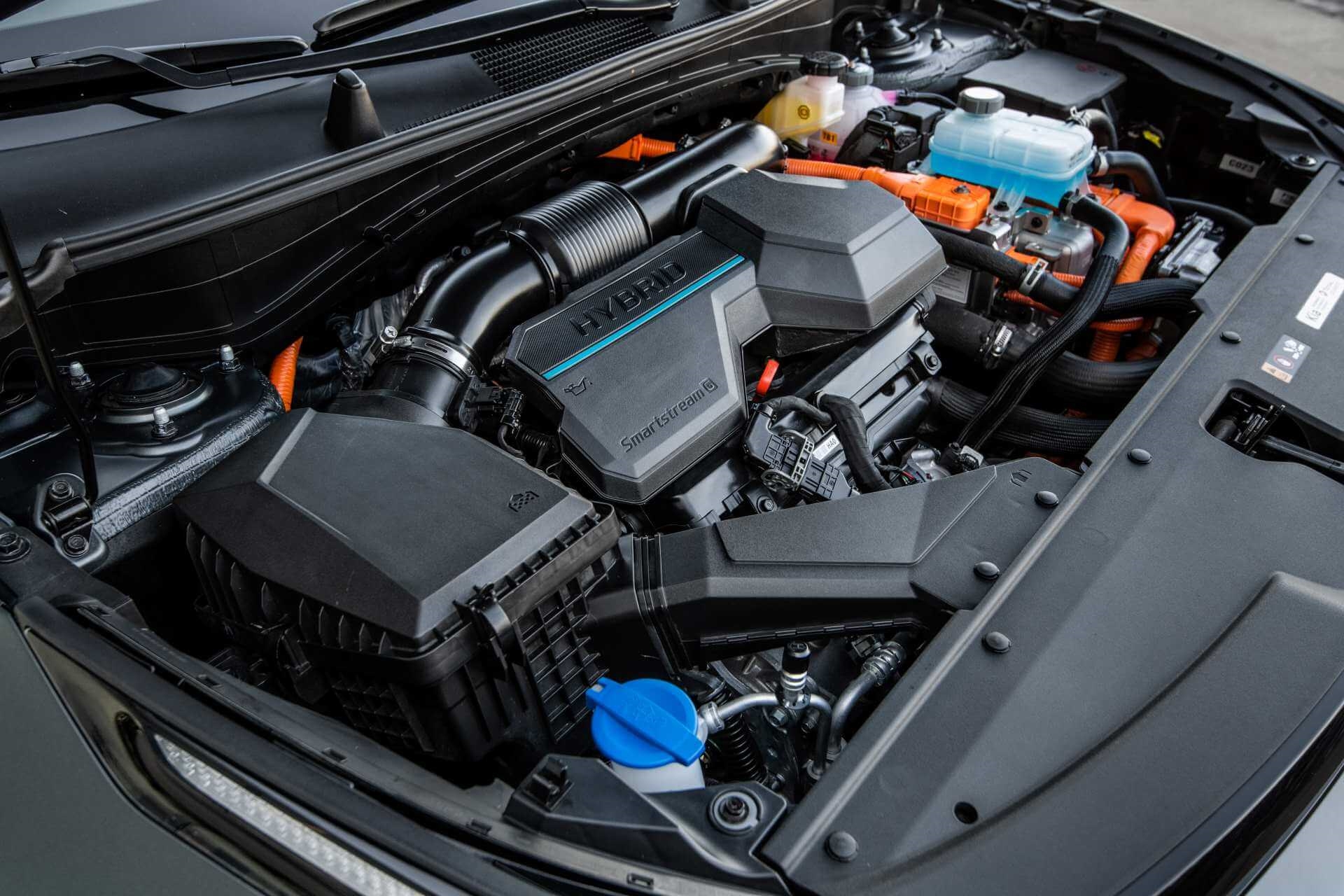 Under-the-hood closeup of the PHEV engine in newer Kia Sportage models, reliably producing great mileage in various hybrid options.