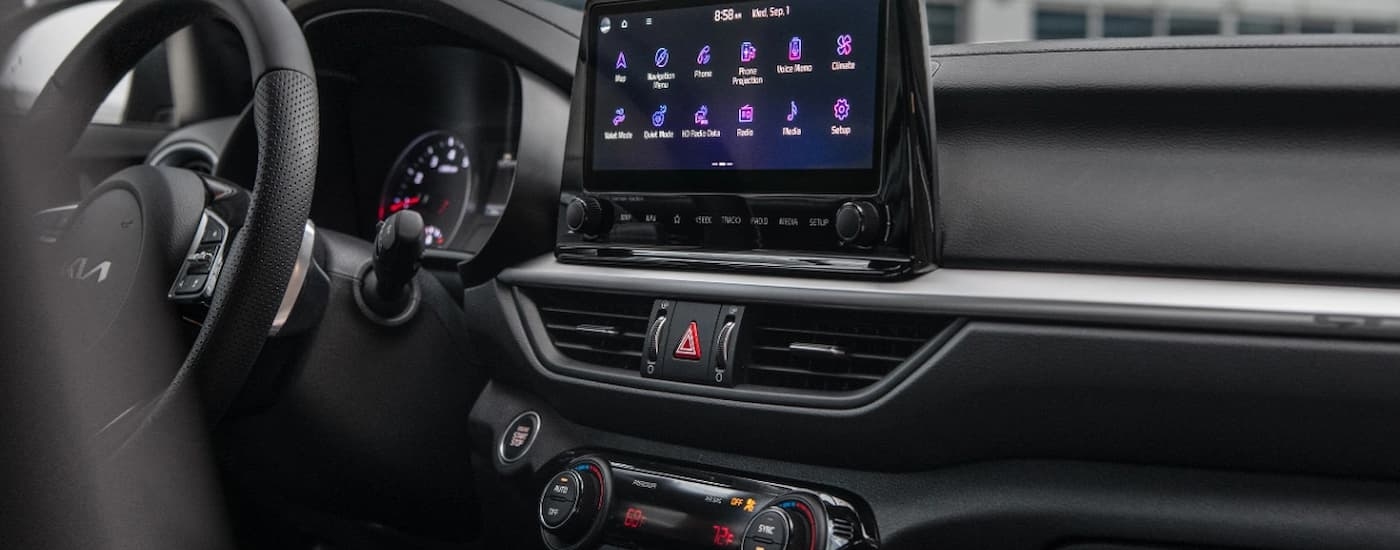 A close up of the infotainment screen and center console of a 2024 Kia Forte.