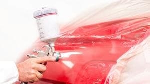 repaired vehicle being applied touch up paint