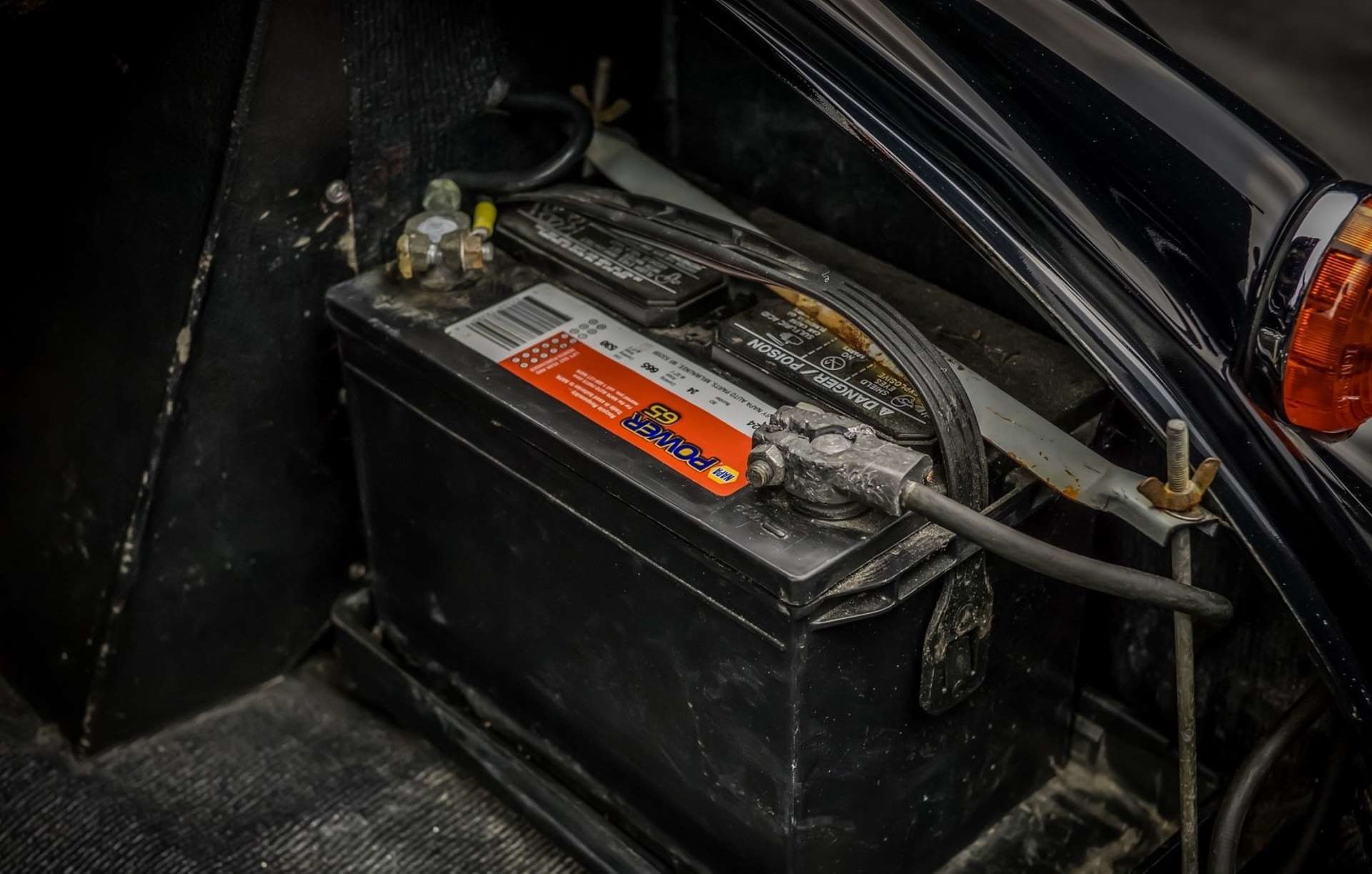 Old Napa battery in trunk of vintage car