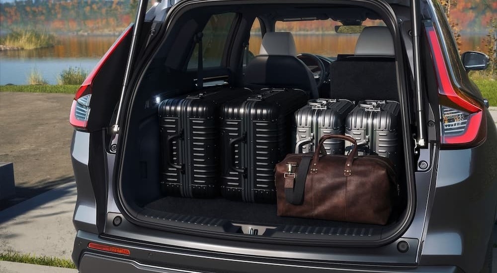 The rear cargo area in a gray 2024 Honda CR-V Hybrid is shown.