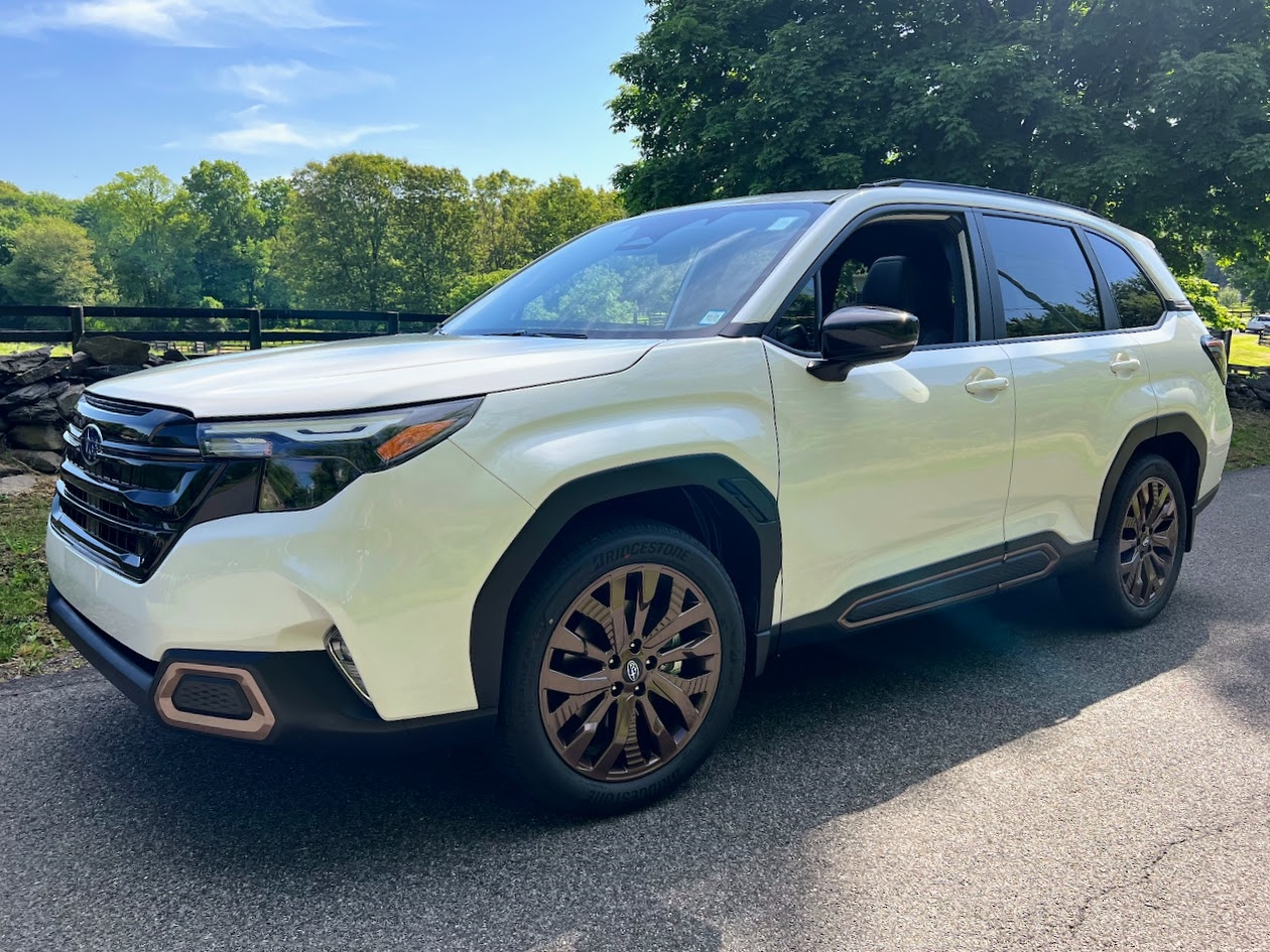 A blue 2025 Subaru Forester  is shown from the front at an angle after leaving a dealer that has a Subaru Forester for sale in Rhinebeck.