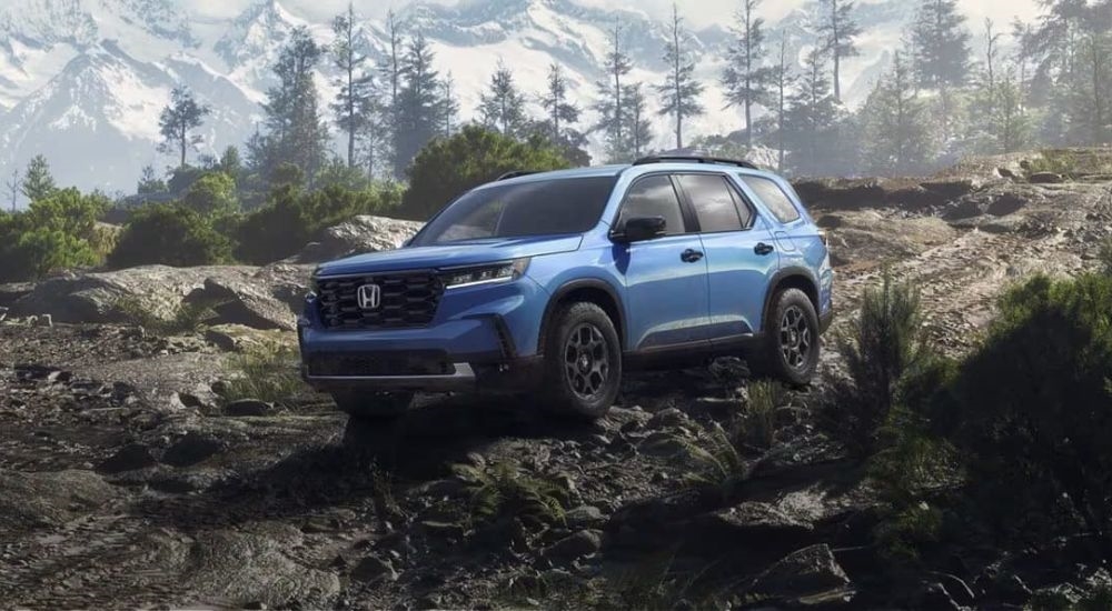 A blue  2025 Honda Pilot is shown off-road after leaving a Honda Dealer in Middletown.