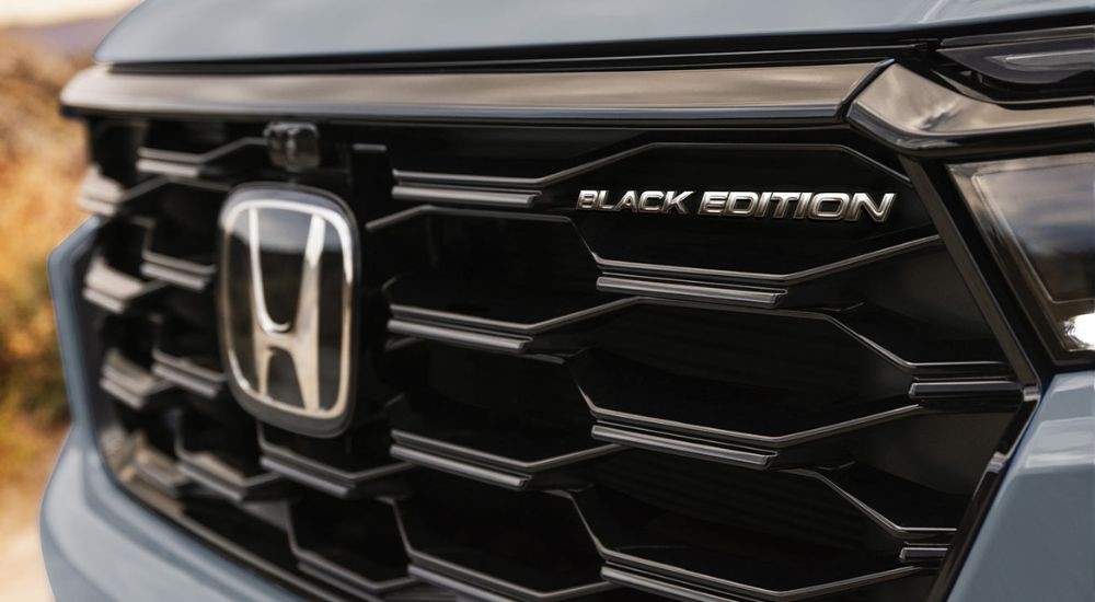 A close up shows the grille on a grey 2025 Honda Pilot Black Edition.